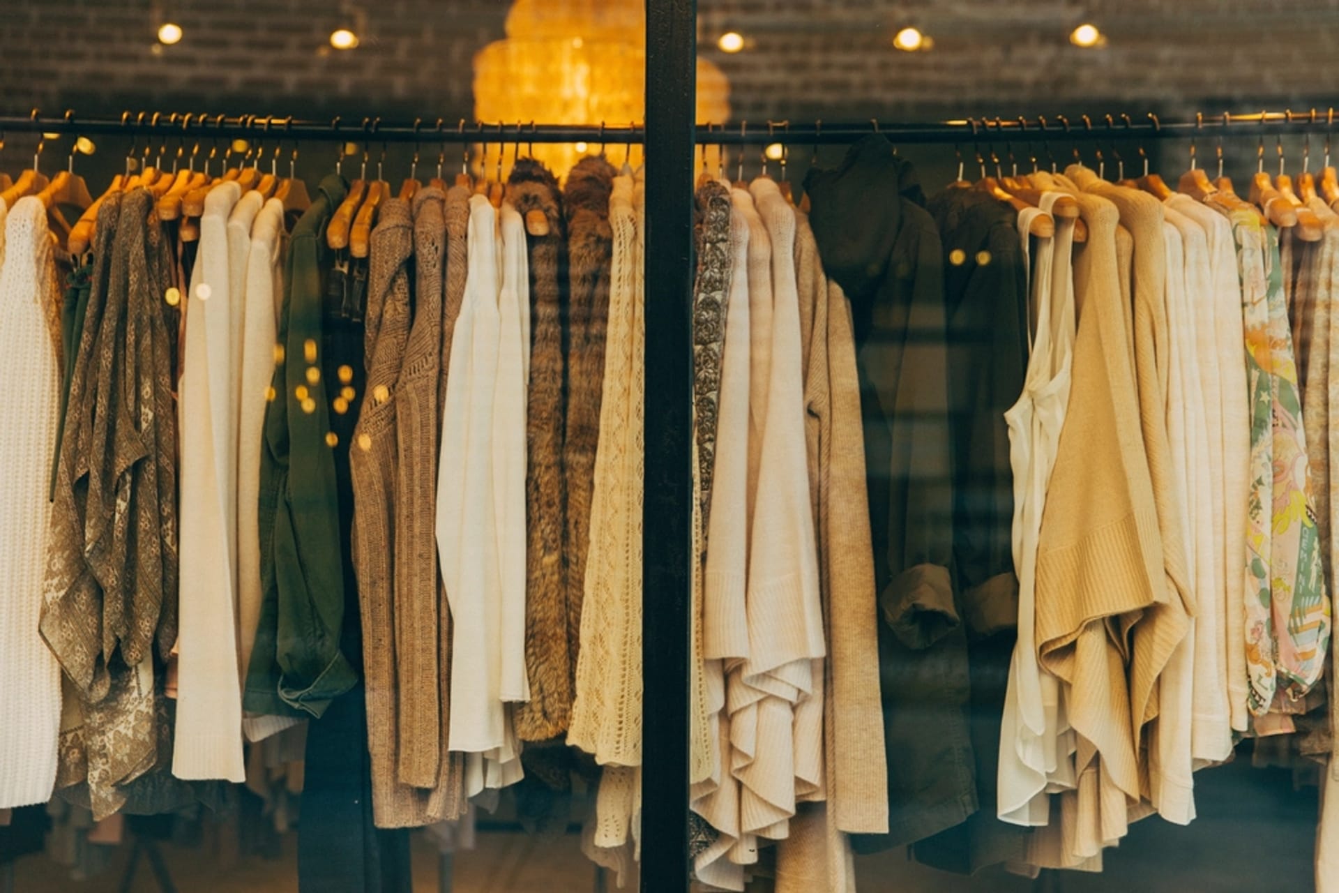 A rack of curated, neutral-toned clothing in the boutique